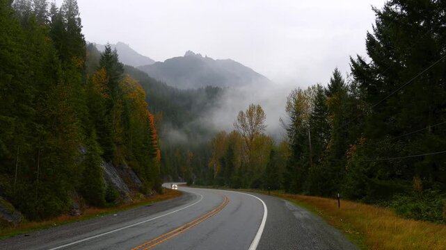 Scenic highway number 2 through North Cascades national forest caught in fog at Stevens pass.