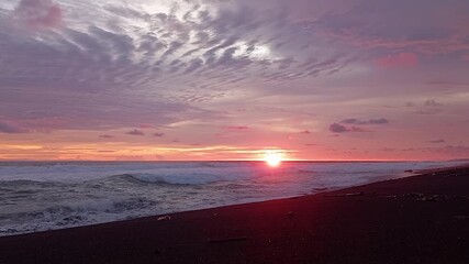 Dramatic Glow Sunset Over Black Sand Beach and Crashing Waves_Ocean Power: Intense Sunset at the Coastal Edge_Purple & Gold: Nature's Spectacular Finale