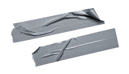 Torn Tape Strips: Two rectangular pieces of gray tape with torn edges lie scattered, showcasing their use and wear, offering a sense of function and practicality.
