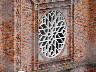 Circular geometric window on brick wall
