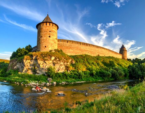 Medieval Fortress on a Hill Overlooking a River on a Sunny Day.