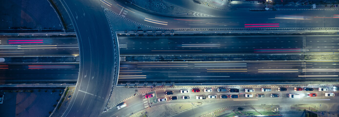 Expressway top view, Road traffic an important infrastructure, car traffic transportation above intersection road in city night, aerial view cityscape of advanced innovation, financial technology	