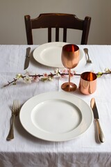 Elegant table setting with copper accents and floral arrangement for a special occasion