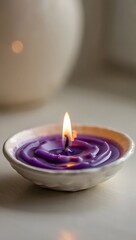 Purple candle in a ceramic bowl with a soft glow and a warm inviting ambiance light