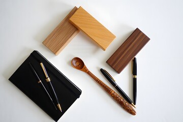 Stationary items and wooden objects arranged on a white surface top down view photo
