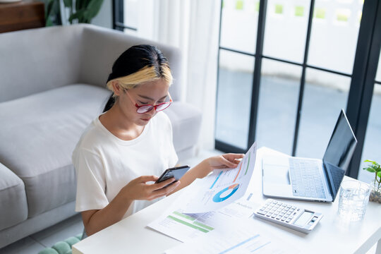 Asian Woman Managing Finances pay Bills and Budget financial at home.