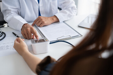 Doctor checking  patient arterial blood pressure. Health care measuring blood pressure of patient