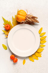 Stylish autumn table setting with pumpkins and leaves on white background