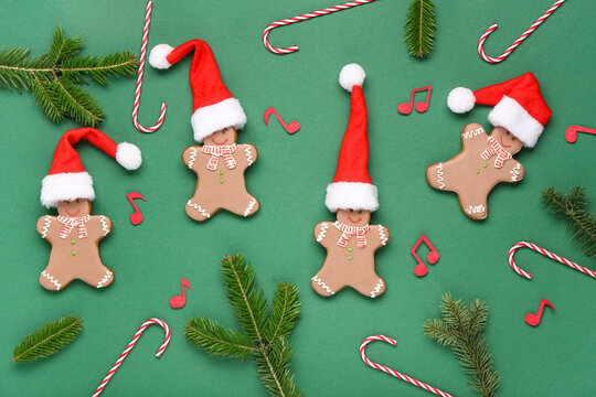 Composition with Christmas cookies, decorations and note signs on green background