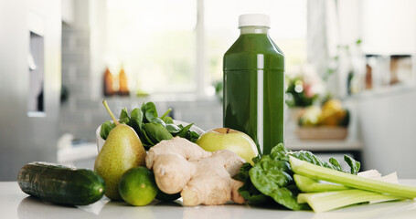 Green, ingredients and bottle in kitchen for detox, vitamin drink and wellness benefits. Nutrition,...