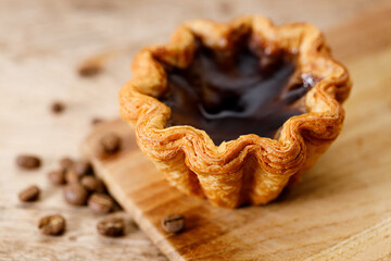 coffee Portuguese sweet dessert egg tart on wooden table.