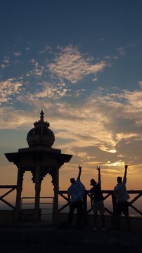 Silhouettes of people helping each other on top of a mountain at Samai Mata Mandir, Banswara, near Udaipur, Rajasthan, India.