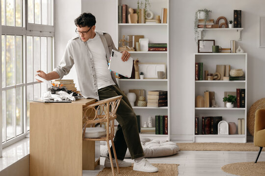 Male screenwriter using typewriter on table in office