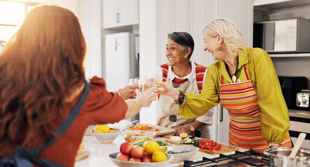 Cooking, kitchen and mature women with toast for bonding, conversation or culinary lesson. Happy, social reunion and senior friends with cheers, alcohol and food for learning recipes together in home