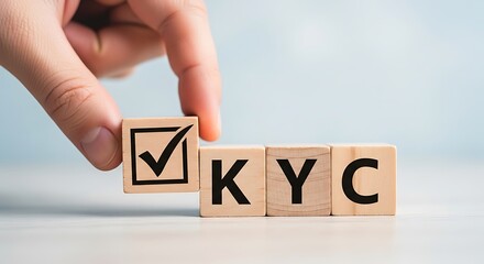 Hand placing a checkmark on a wooden block, completing the kyc process, representing identity verification and customer onboarding