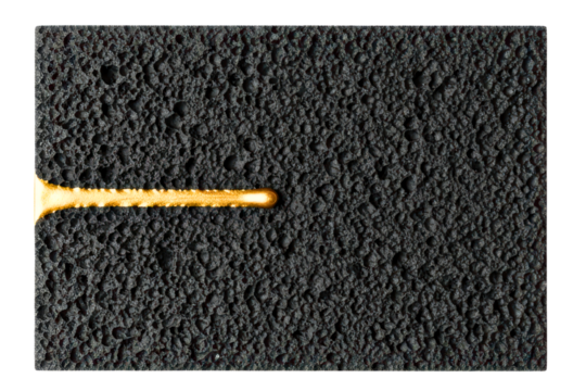 Molten gold flowing on a black porous volcanic rock texture isolated on transparent background - Powered by Adobe