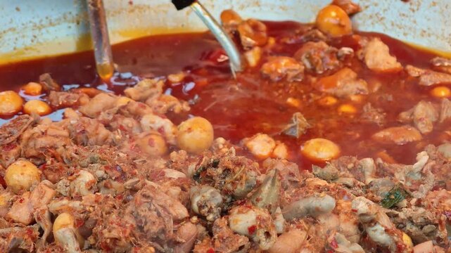Spicy chicken offal curry in the market