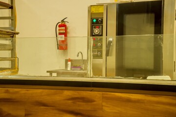 Commercial kitchen with stainless steel oven, sink, and fire extinguisher