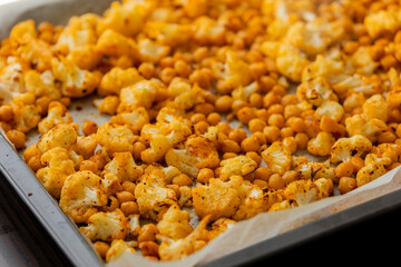 roasted hot cauliflower and chickpeas in tray close up