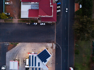 intersection of roads by service station at dusk seen from aerial perspective