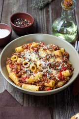 Pasta with bolognese sauce and cheese. Italian cuisine. Traditional recipe.