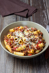 Pasta with bolognese sauce and cheese. Italian cuisine. Traditional recipe.