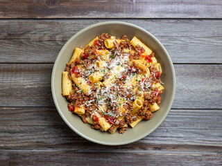 Pasta with bolognese sauce and cheese. Italian cuisine. Traditional recipe.