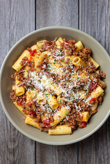 Pasta with bolognese sauce and cheese. Italian cuisine. Traditional recipe.