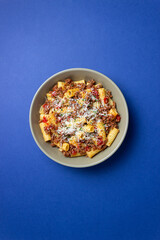 Pasta with bolognese sauce and cheese. Italian cuisine. Traditional recipe.
