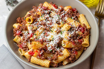 Pasta with bolognese sauce and cheese. Italian cuisine. Traditional recipe.