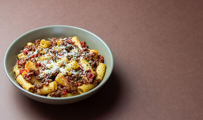 Pasta with bolognese sauce and cheese. Italian cuisine. Traditional recipe.