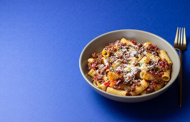 Pasta with bolognese sauce and cheese. Italian cuisine. Traditional recipe.