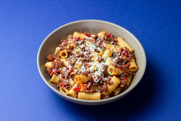 Pasta with bolognese sauce and cheese. Italian cuisine. Traditional recipe.