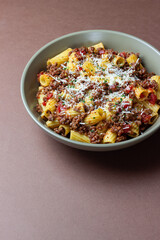 Pasta with bolognese sauce and cheese. Italian cuisine. Traditional recipe.