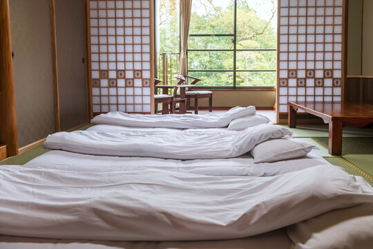 Japanese tatami floor bed by sliding screen and seat at balcony