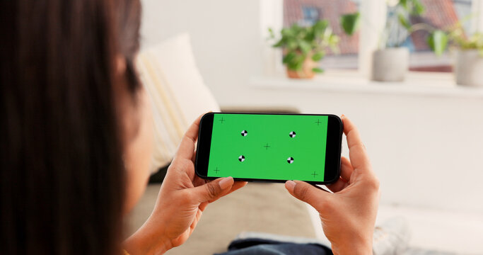 Back, green screen or woman on sofa for phone, streaming or entertainment app in ux design. Digital, video binge or female person in house with tech, chroma key or mockup on smartphone display.