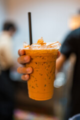 A cup of thai milk tea make she fresh and cool down.