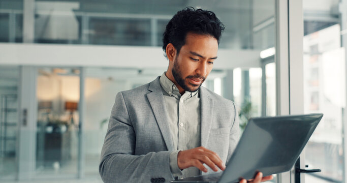 Typing, info and businessman with laptop, office and financial analysis on web, online and research. Investment banker, person and planning for pitch with tech, browsing and checking market data - Powered by Adobe