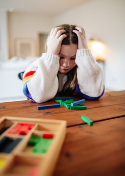 Young preteen girl with hands on her head looking frustrated