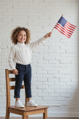 Young Child with National Flag - Patriotic Celebration Gesture on Wooden Chair for Independence Day Festivities and Cultural Heritage Recognition