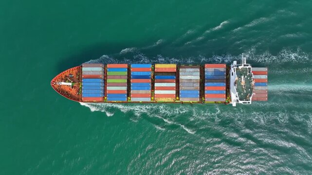 Aerial shot of cargo ship moving through ocean, global trade and logistics theme, blue-green water patterns, cinematic drone motion, 8K HDR detail. 