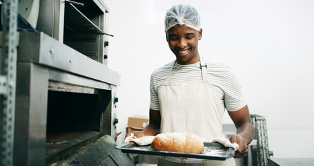 Bread, baker and oven with black man in kitchen for cooking, culinary process or food production....