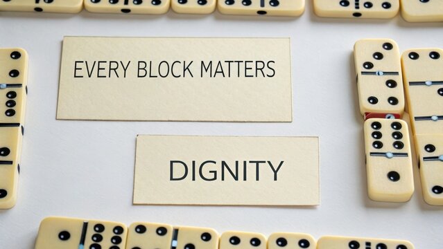 Dominoes Displaying Dignity and Every Block Matters Message