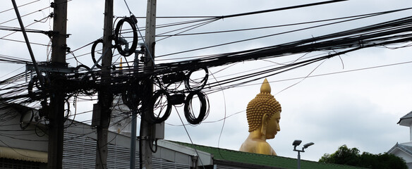 A Buddha and wire on the poles 