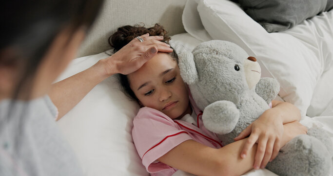 Mother, sick child and check for fever in bed, support and monitor illness symptoms of daughter. Comfort, teddy bear and woman care for sad girl with temperature, virus infection and touch forehead - Powered by Adobe