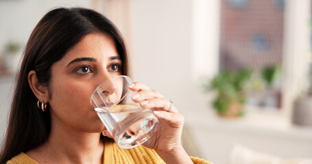 Woman, relax and drinking water with glass at house space for hydration, refreshing liquid and...