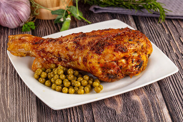 Baked turkey drumstick served green peas