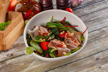 Salad with jamon, strawberry and arugula