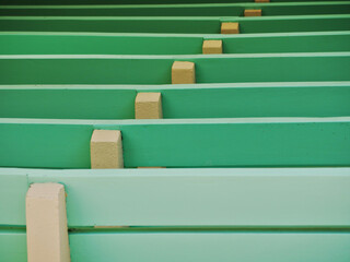 Obraz premium rows of wooden seats in an open air theater painted in colorful green