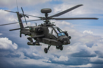 Military Apache Helicopter Flying at Low Altitude